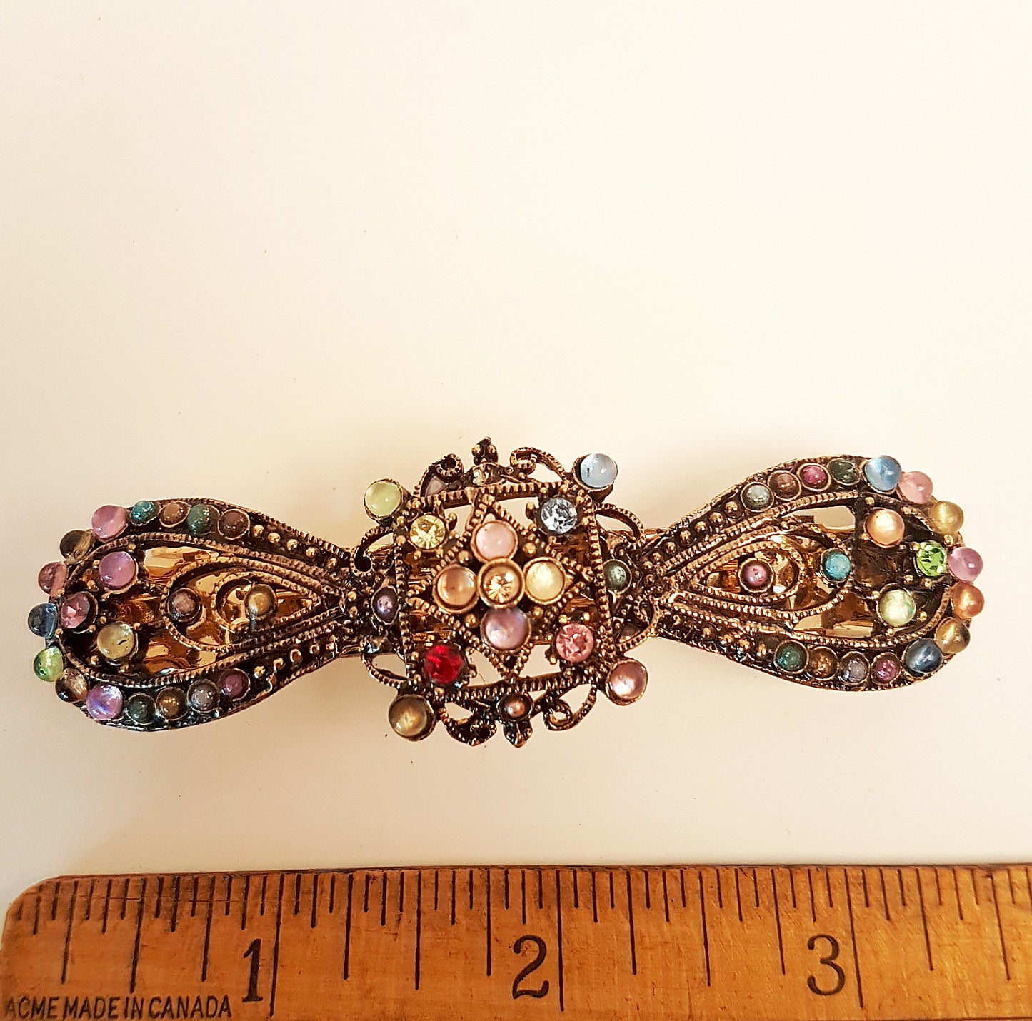 Vintage rhinestone hairclip barrette. Antique silver finish hair jewelry. Bow shaped hair clip studded with colorful stones. 3.75 inches.