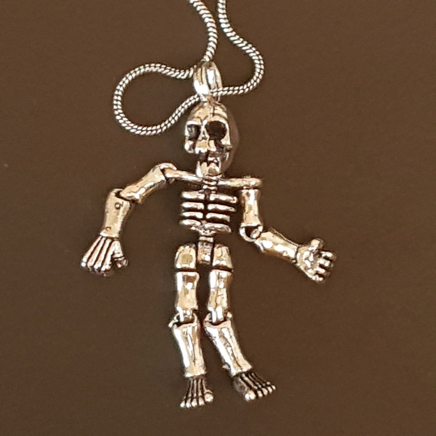 Halloween skeleton pendant necklace on 20 inch chain. Moveable arms and legs. Articulated limb skeleton puppet pendant. Gold & silver. - Vintage India Ca