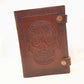 Brown leather embossed skull journal 5 by 7 inches. Exclusive double snap tab closure system.