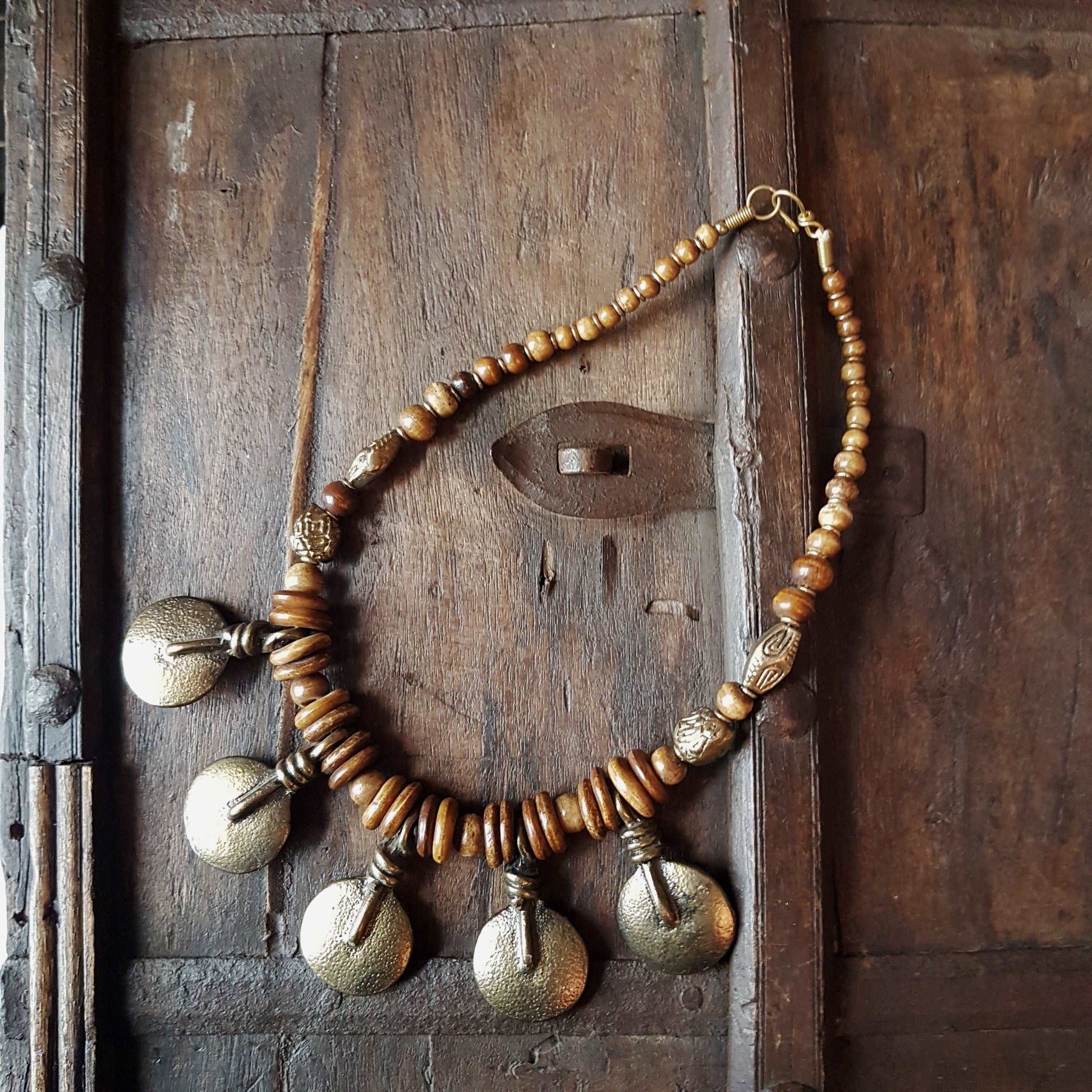 Bronze metal disc pendant necklace with rustic handmade beads.  Classic old world tribal design 19 inches long. Versatile casual to dressy.