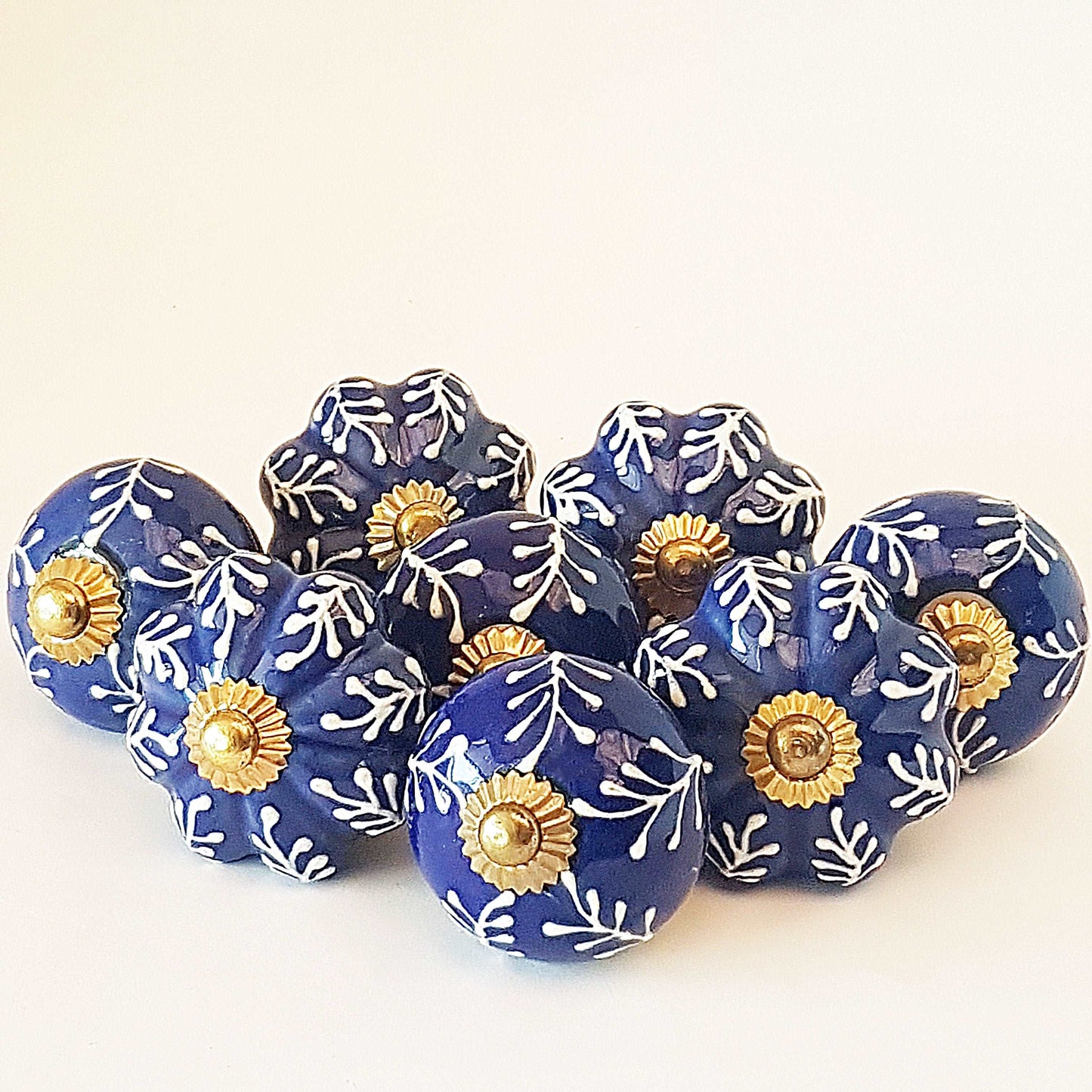 8 Delft cabinet knob drawer pulls in cobalt blue & white hand painted embossed designs. Exclusive Regal Gold  8 piece decorator collection.