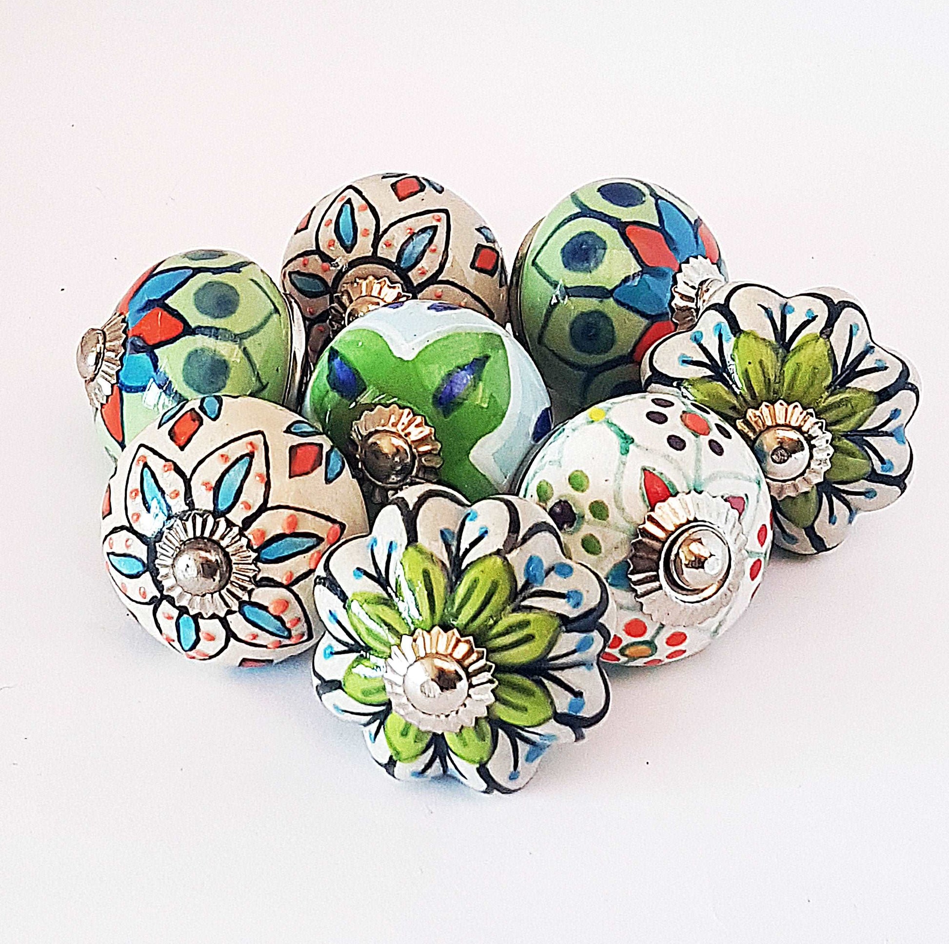 8 hand painted drawer pull cupboard knobs. Exclusive hand painted 8 piece set in blue, green & white floral patterns with silver centers.