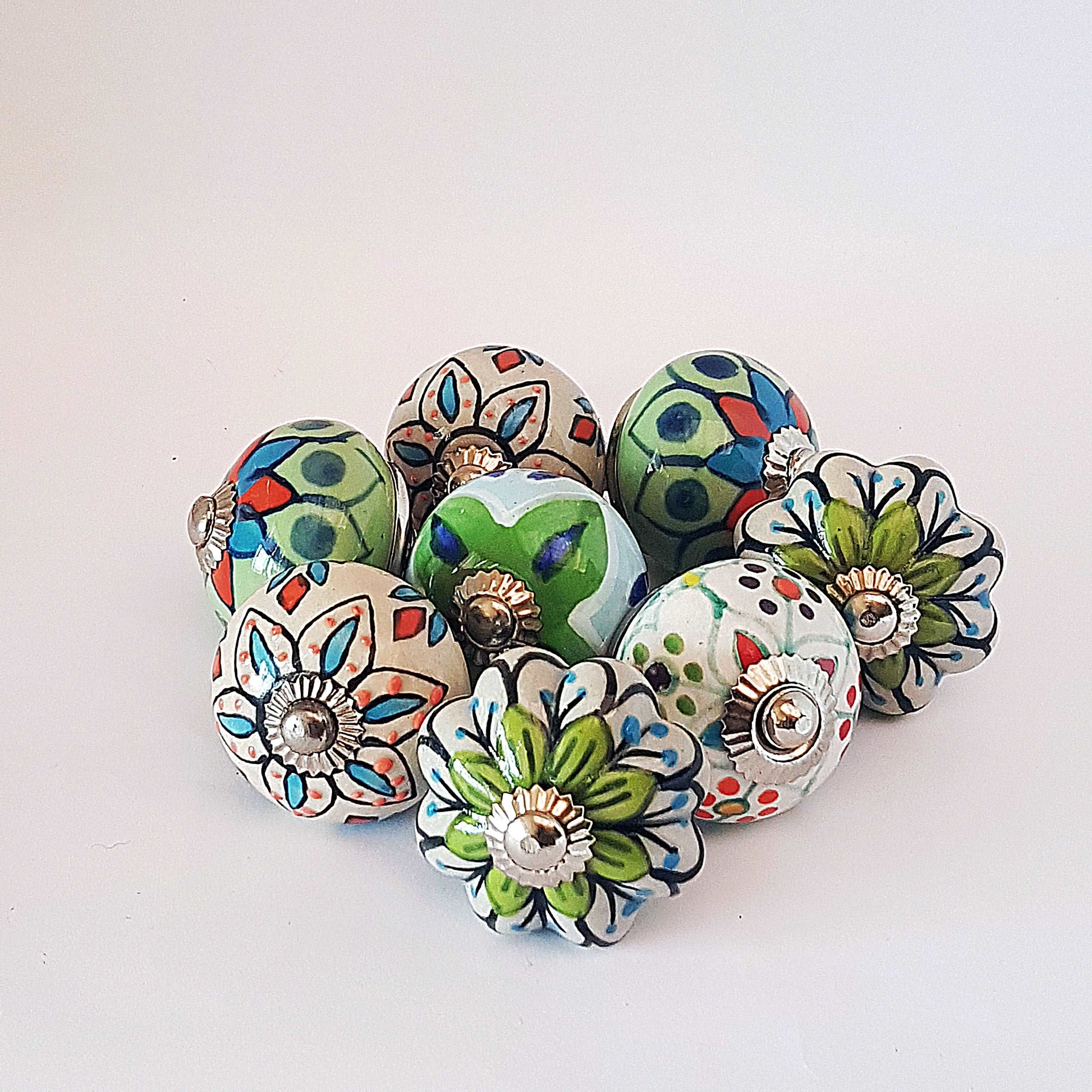 8 hand painted drawer pull cupboard knobs. Exclusive hand painted 8 piece set in blue, green & white floral patterns with silver centers.