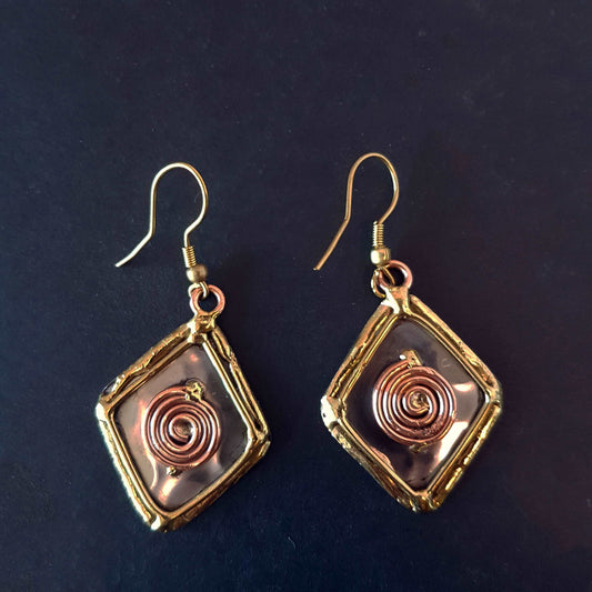 Celtic silver earrings in a diamond shape with gold and copper tone wirework detail.