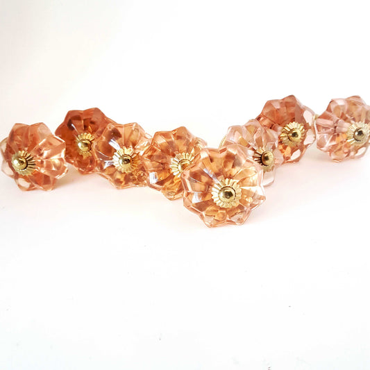 8 cranberry glass cabinet knobs with gold tone accents. Pink crystal look cut glass drawer pulls. For kitchen cupboards, dressers, vanities.