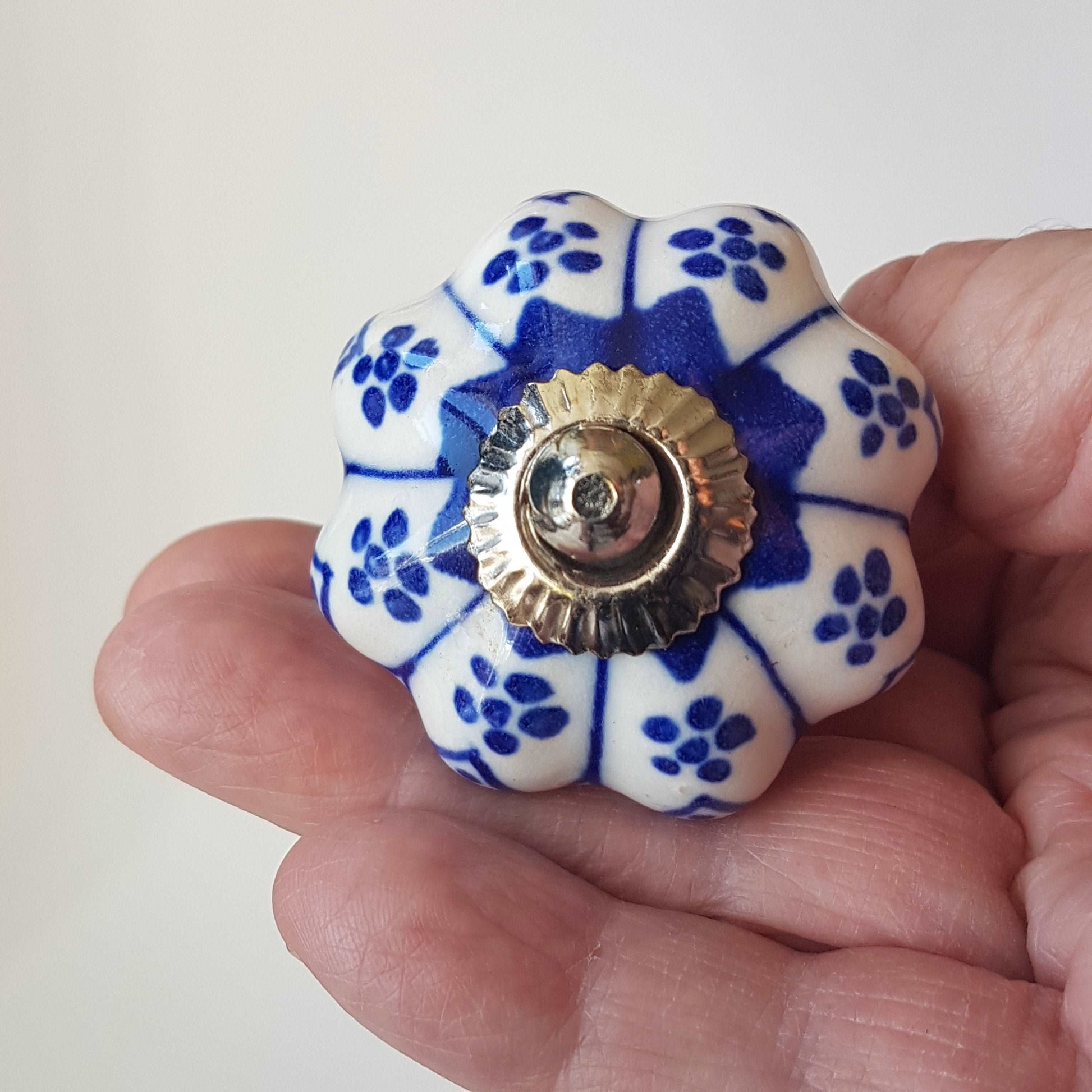 Ceramic cupboard-drawer knobs-pulls set of 8. Blue and white, unique hand painted floral designs. One and a half inch diameter.