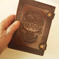 Brown leather embossed skull journal 5 by 7 inches. Exclusive double snap tab closure system.