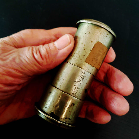 Antique bronze paan container. Cylinder shape with 2 compartments which unscrew. Hand punched dot inscription. 4 by 1 and a half inches.