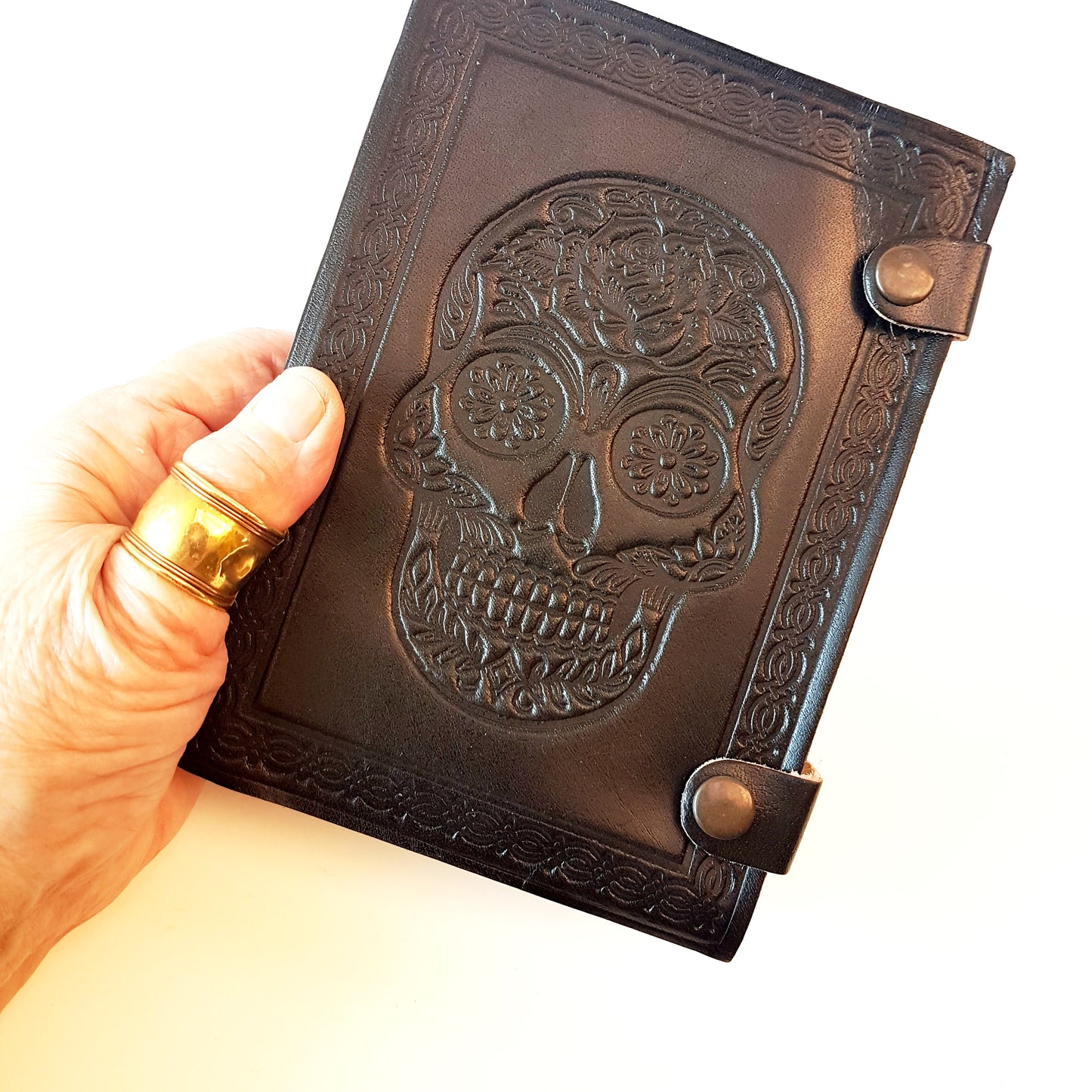 Genuine black leather bound sugarskull design journal. Black 5x7 inch skull grimoire with blank premium quality paper pages.
