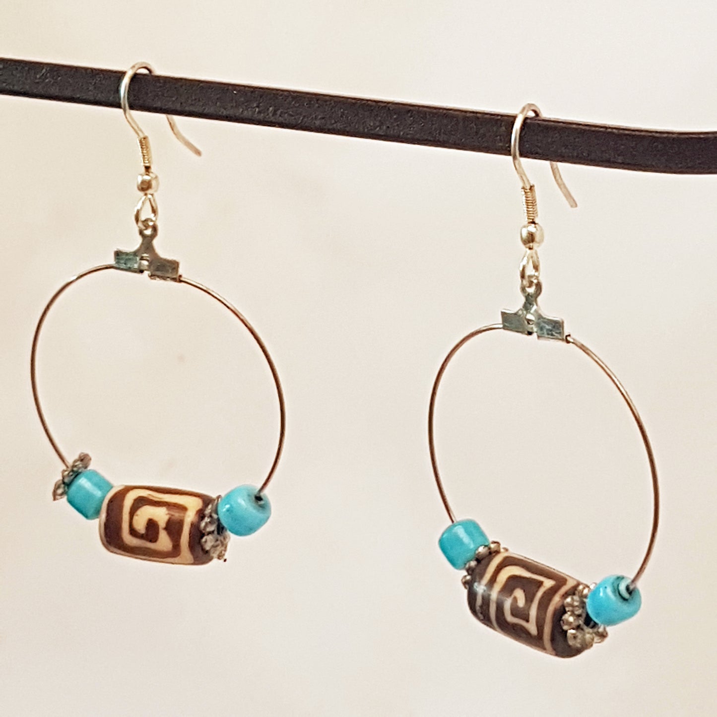 Silver hoop earrings with Dzi bead & small turquoise stones.