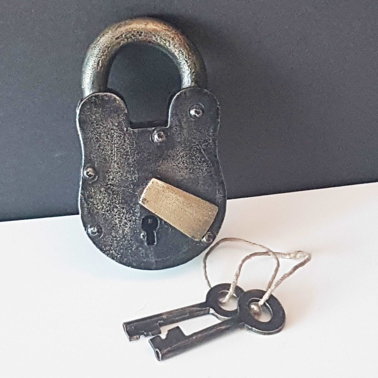 Antique metal pad lock in iron & bronze.  Padlock 4 by 3 inches with 2 vintage keys. Unique old world design. Functional lock collectible.
