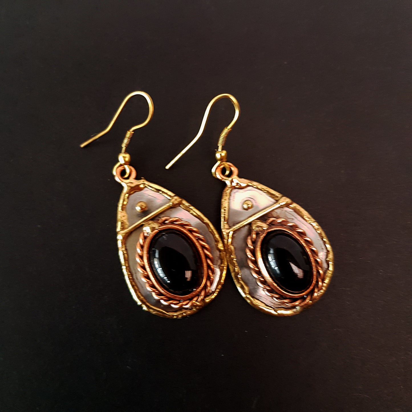 Silver & mixed metal tear drop shape earrings with black onyx oval stones. Hand crafted design in brass, copper and silver.