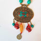 Bohemian designer necklace with turquoise & copal beads. Vintage design embossed bronze metal pendant. Impressive colorful piece.