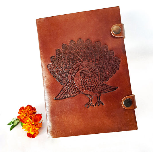 Leather bound journal with peacock design embossed cover. Bird of love motif 5 by 7 inch.