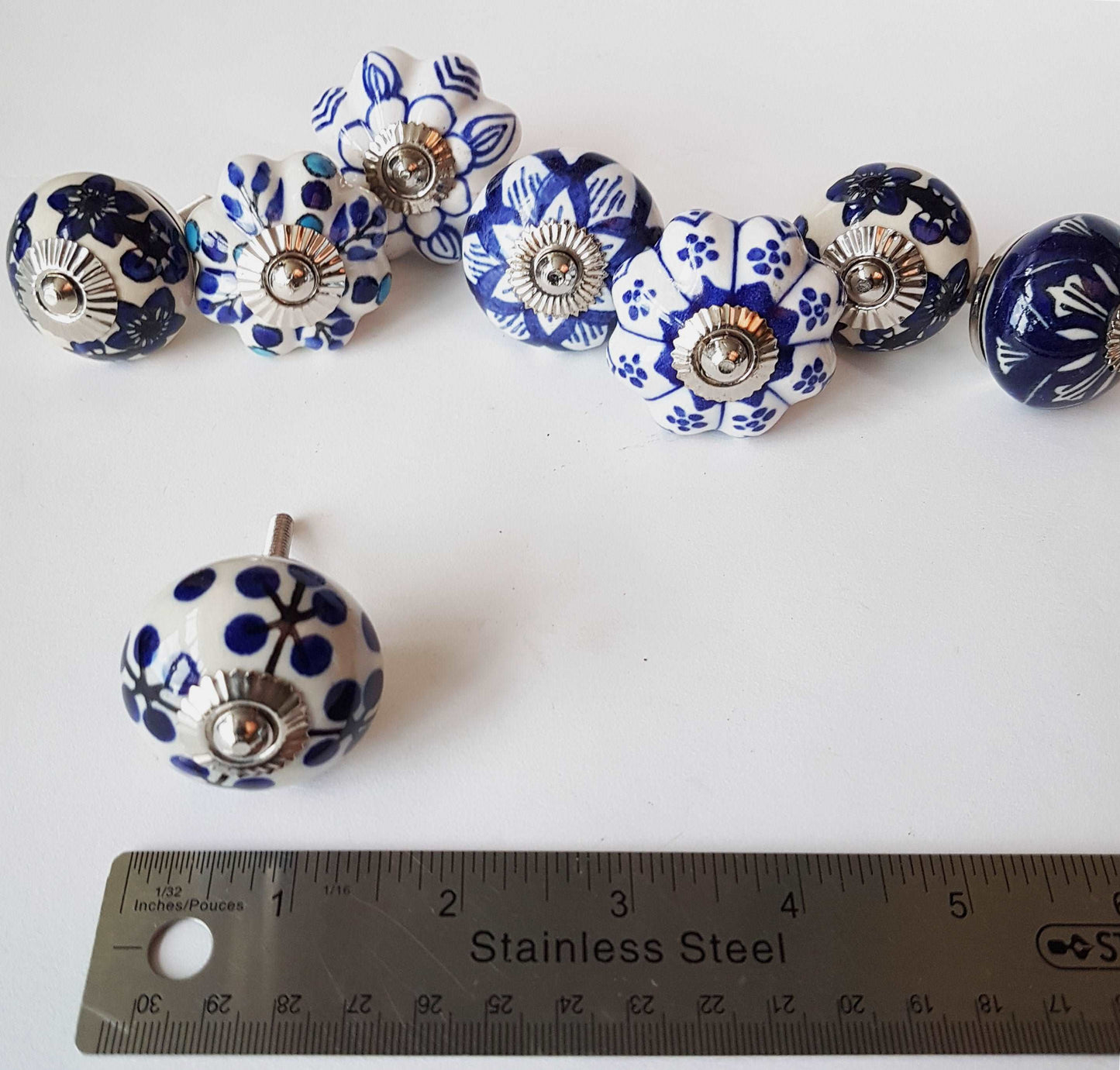 Ceramic cupboard-drawer knobs-pulls set of 8. Blue and white, unique hand painted floral designs. One and a half inch diameter.