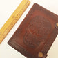 Brown leather embossed skull journal 5 by 7 inches. Exclusive double snap tab closure system.