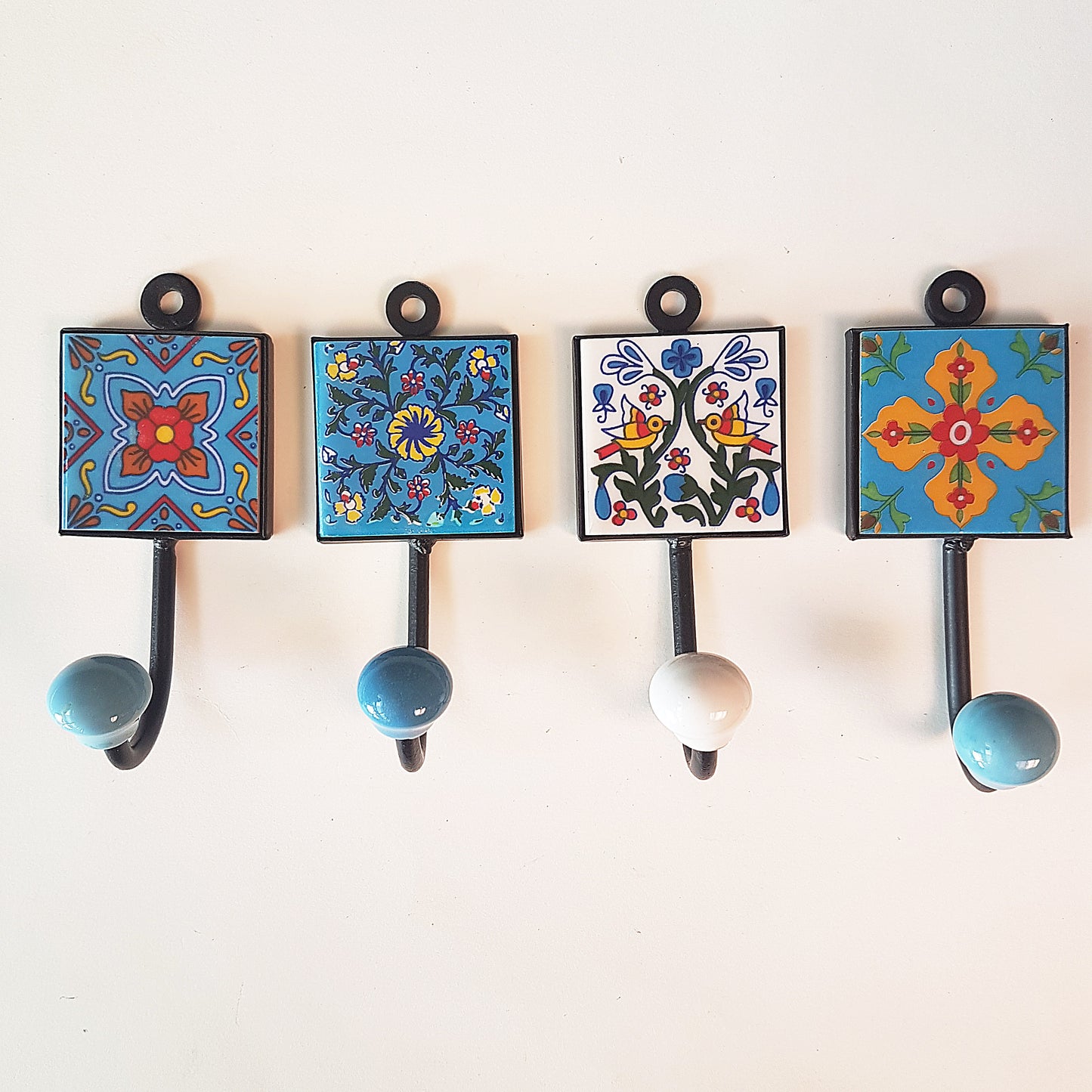 Set of 4 home decor wall hooks in blue, white & yellow.