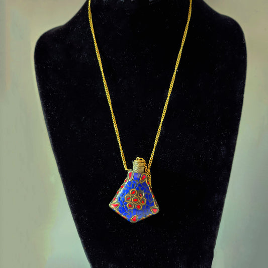 Perfume bottle pendant in a stone mosaic design. Inlaid with lapis. Bottle closes with a brass wand stopper.