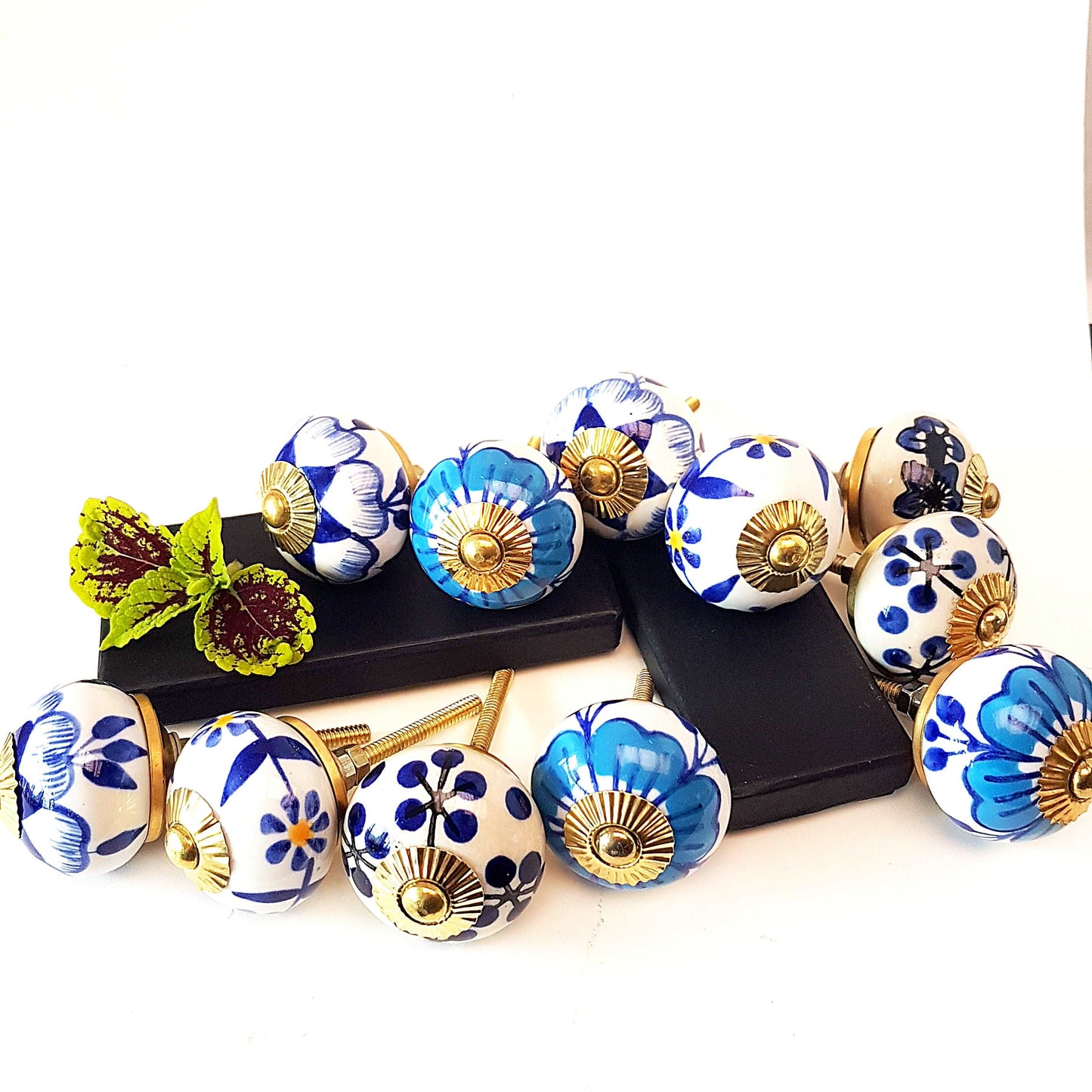 12 Delft blue & white cabinet knob drawer pulls with gold tone metal.