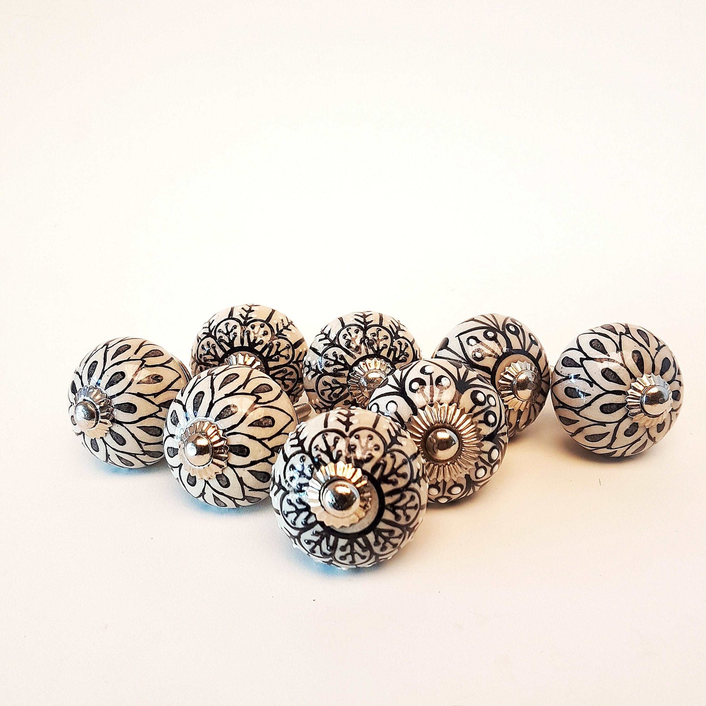8 cabinet knob-drawer pulls in black, slate grey and cream.  Elegance hand painted floral designs with silver hardware.1.5 inch in diameter. - Vintage India Ca