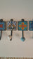 Set of 4 home decor wall hooks in blue, white & yellow.