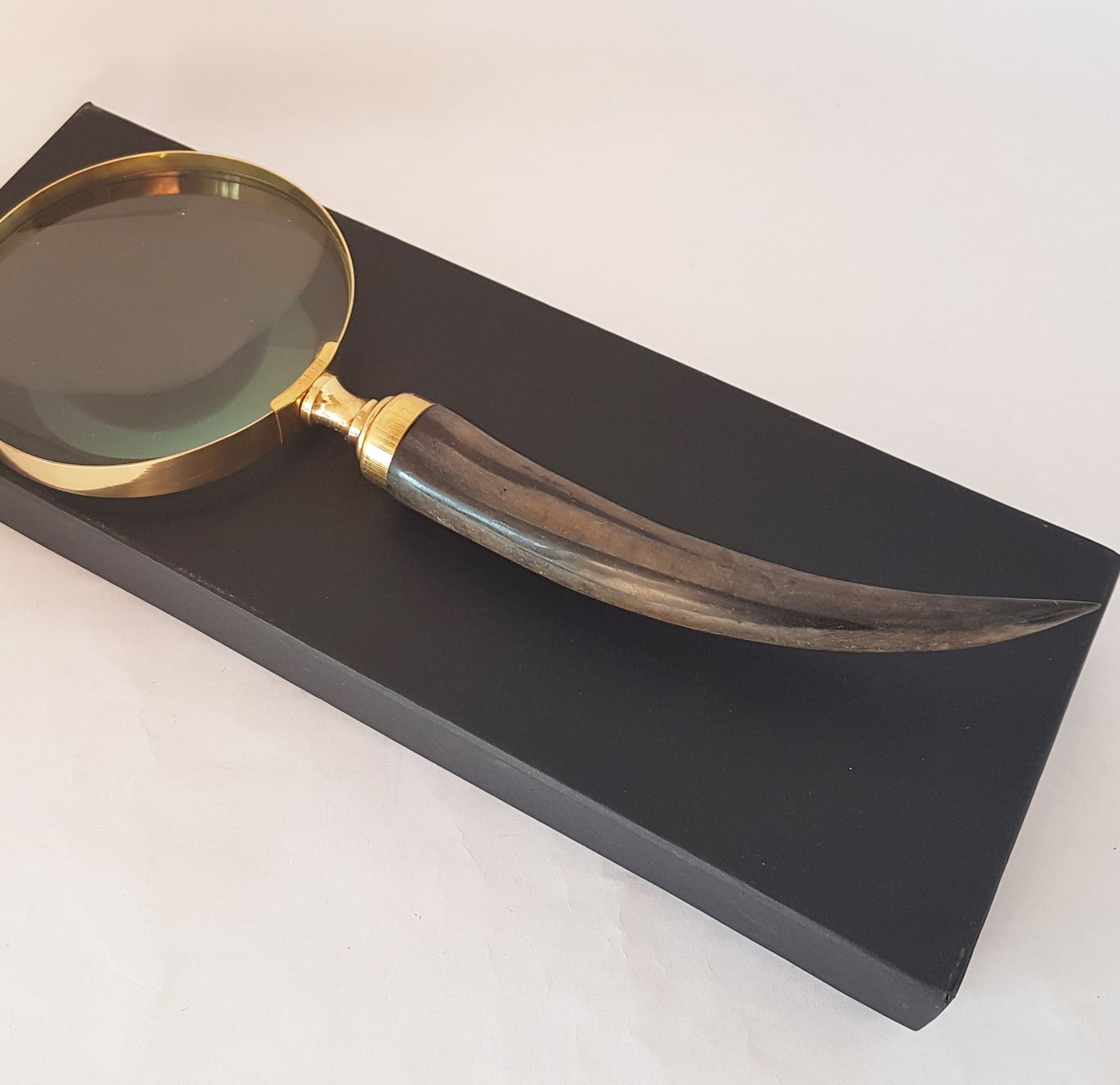 Vintage style magnifying glass hand lens with a curled horn handle. Old world charm. Read small print easily, use for home & hobby. 10 inch.