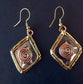 Silver dangle earrings wwith bronze & copper detail. Celtic rhombus diamond shape.
