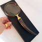 Vintage style magnifying glass hand lens with a curled horn handle. Old world charm. Read small print easily, use for home & hobby. 10 inch.