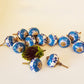 Set of 12 blue & white floral cabinet knobs with gold tone hardware.