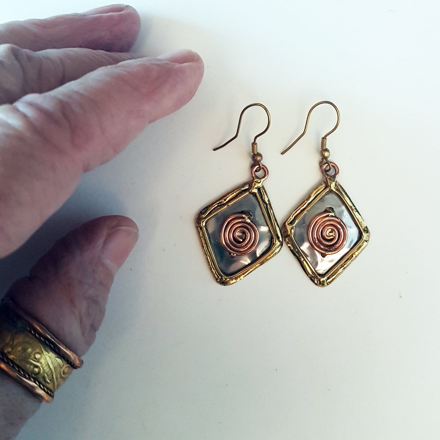 Silver dangle earrings wwith bronze & copper detail. Celtic rhombus diamond shape.