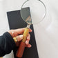 Magnifying glass hand lens in a vintage nautical style 9.5  inches long. 4 inch diameter lens with a marquetry design handle. Gift boxed.