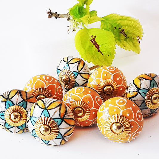 Set of 8 colorful cabinet knob-drawer pulls. Handpainted in aquamarine & apricot designs embossed in cream. Old world Art Deco aesthetic.