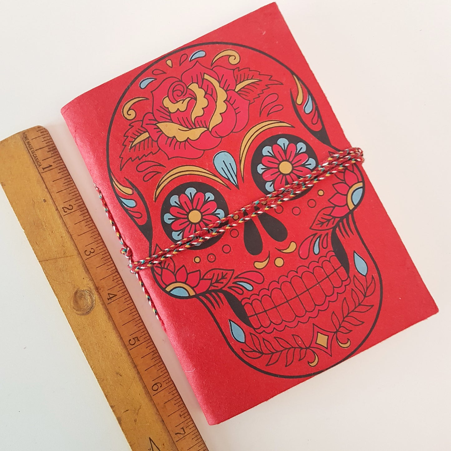 Red skull sketchbook jotter journal 5 by 7 inches with blank artisan paper pages. Colorful gothic day of the dead sugarskull design diary in red.
