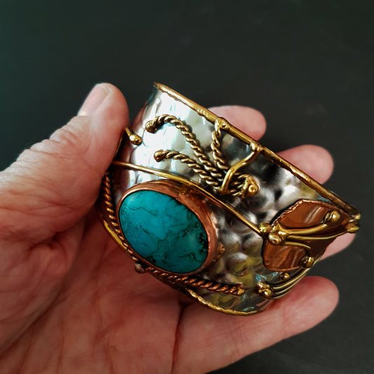 Vintage silver cuff bracelet with a Tibetan turquoise stone. Celtic trimetal medieval handwrought design. Copper & brass on silver metal.