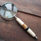 Magnifying glass hand lens in a vintage nautical style 10 inches long. 4 inch diameter lens with a marquetry design handle. Comes gift boxed