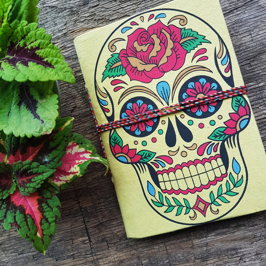 Yellow skull sketchbook jotter 5 by 7 inches with blank artisan paper pages. Colorful lemon gothic day of the dead sugarskull design diary.
