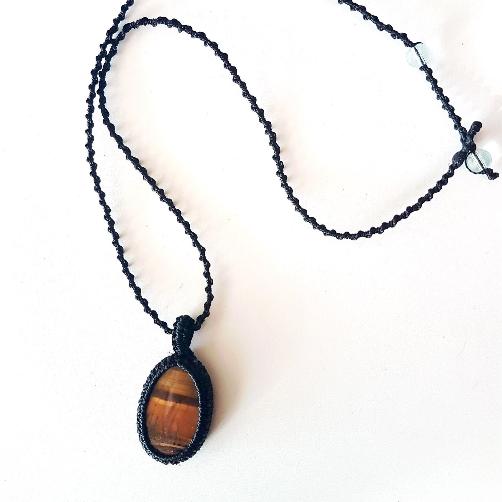 Gender neutral design tigereye pendant necklace. Hangs on a 20 inch black woven corkscrew knot cord. Adjustable length. Unisex jewelry. - Vintage India Ca