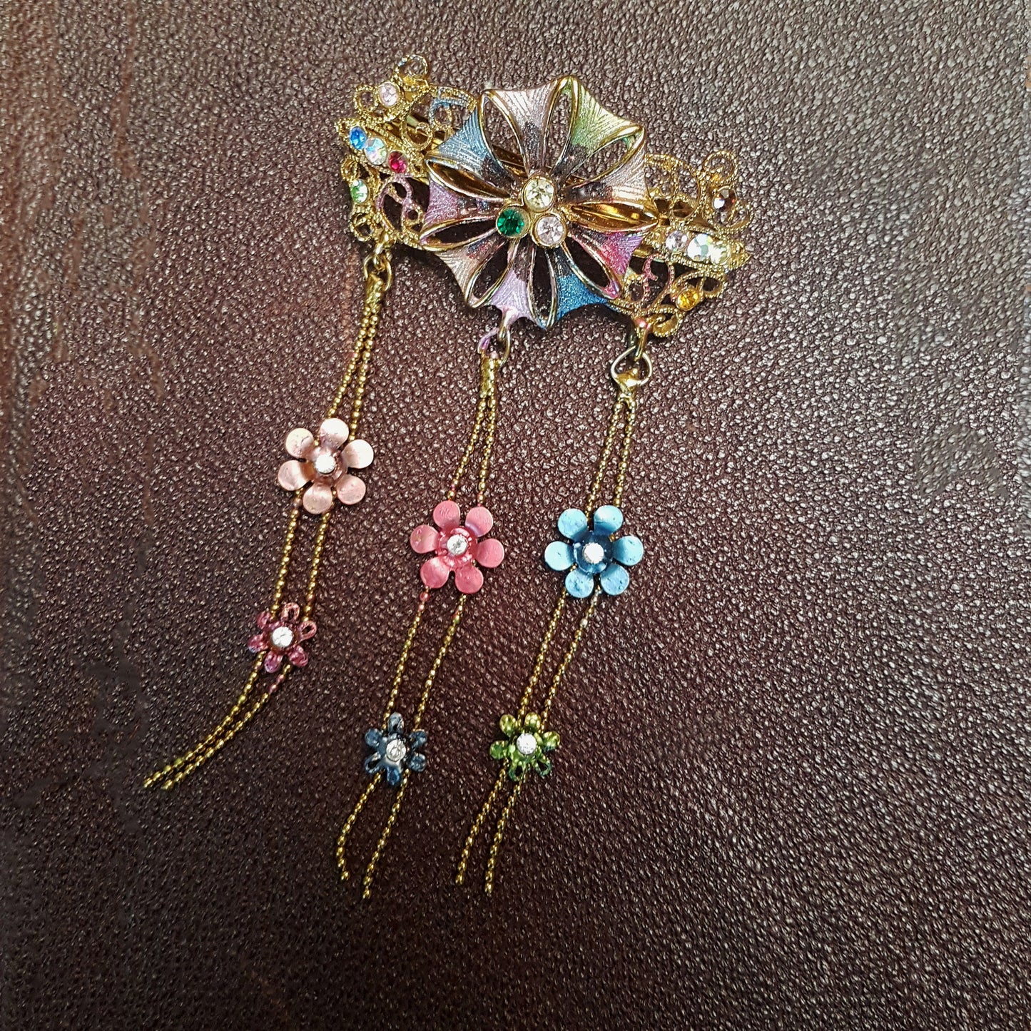 Vintage hairclip barette in a  medieval flower design. Hair jewelry with rhinestones in soft rose and blue tones.  Gold metal details.
