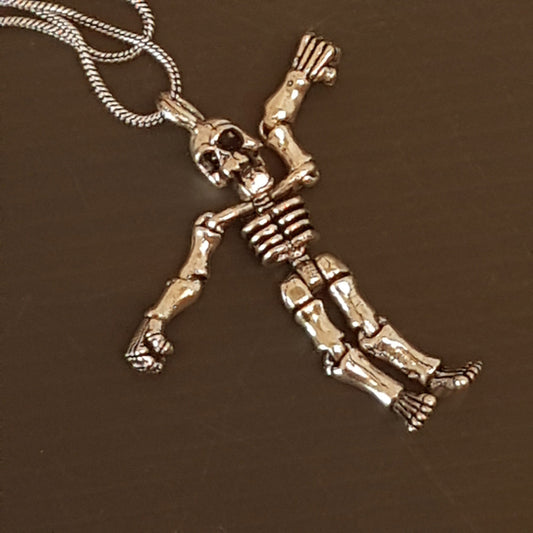 Halloween skeleton pendant necklace on 20 inch chain. Moveable arms and legs. Articulated limb skeleton puppet pendant. Gold & silver. - Vintage India Ca