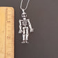 Halloween skeleton pendant necklace on 20 inch chain. Moveable arms and legs. Articulated limb skeleton puppet pendant. Gold & silver. - Vintage India Ca